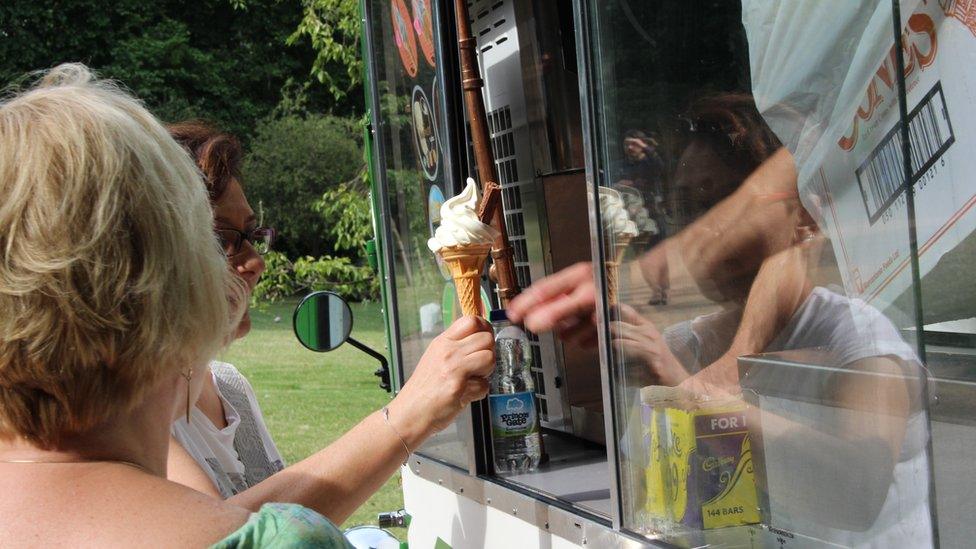 Woman being served at an ice cream van