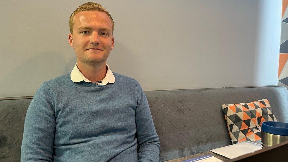 Bradley Latty-Williams sitting on a bench in the Mon CF office