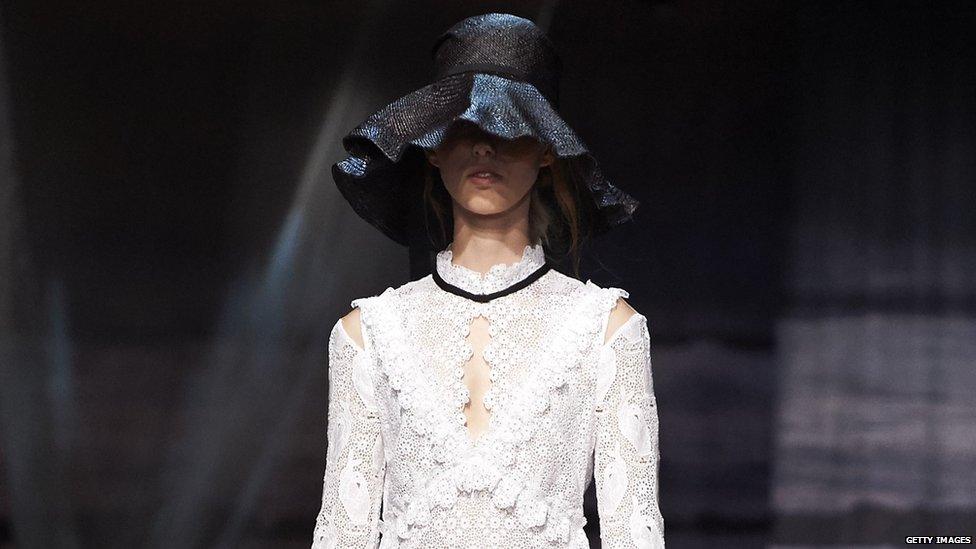 A white dress and black hat by Erdem