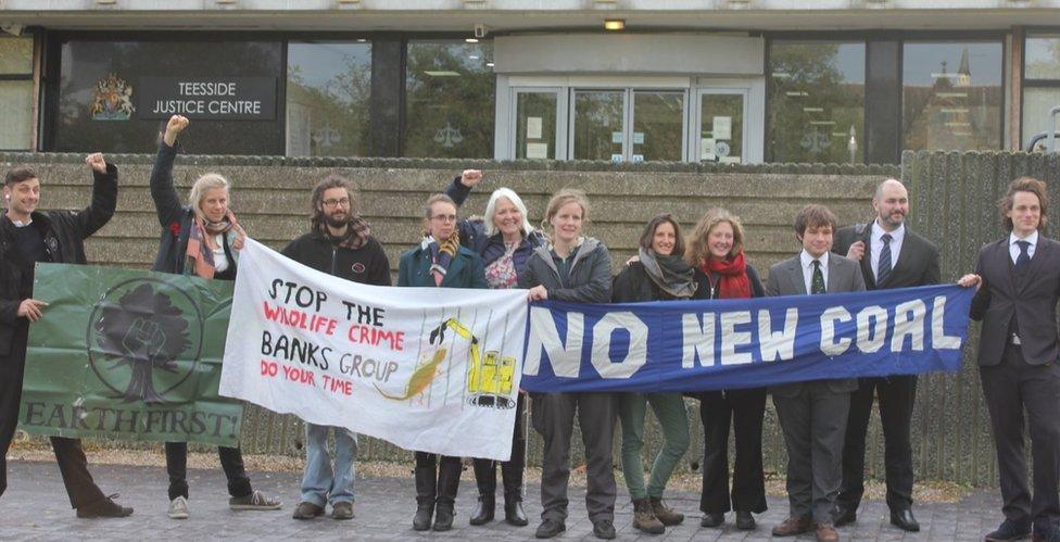 Defendants and supporters outside court