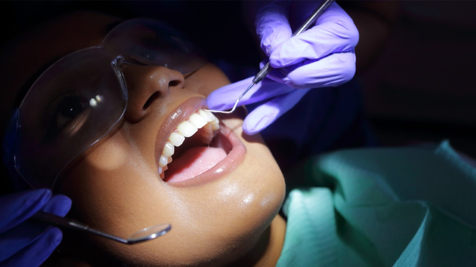 Woman being seen by a dentist