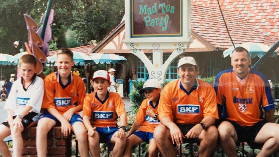 Alex, in the white shirt, (left) with his father, Paul, (right) and brother Greg, next to him