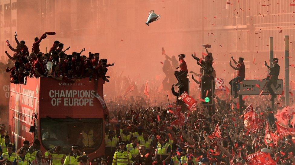 team celebrate with fans on parade