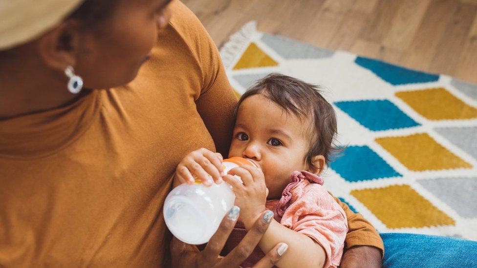 Baby drinking milk from bottle