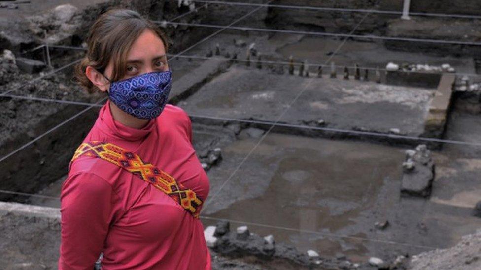 Archaeologist Ximena Castro poses in front of the excavated altar