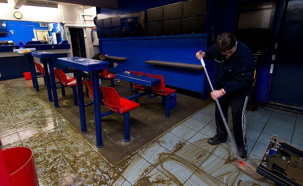 Man mops out flooded bookmakers in Tadcaster December 2015