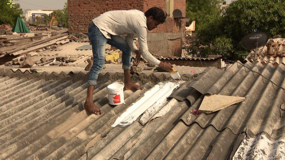 Painting roofs with white reflective paint helps reduce the heat