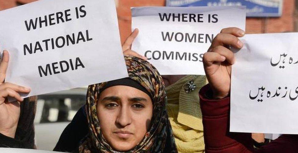 Activists holding placards during a protest in Srinagar over the rape and murder of a child.