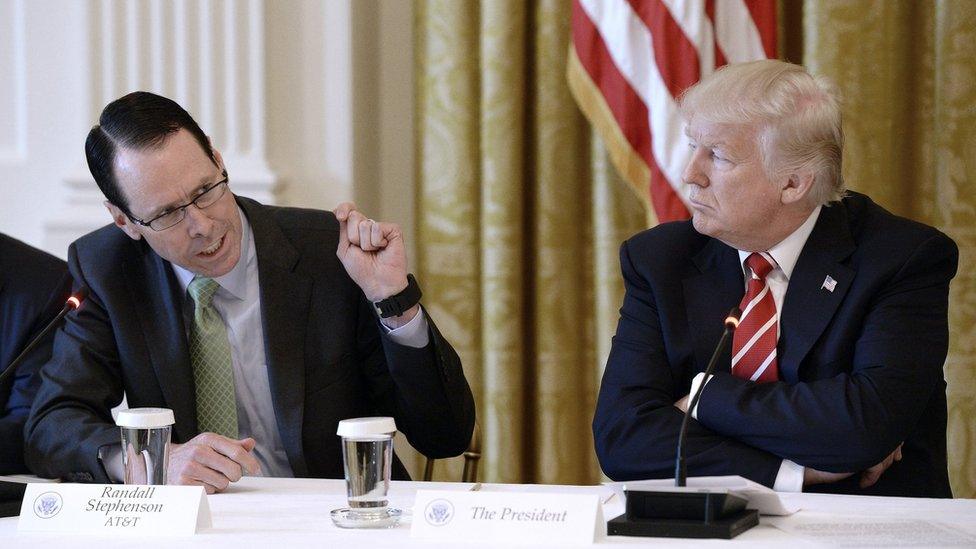 AT&T chief executive Randall Stephenson (L) and President Donald Trump