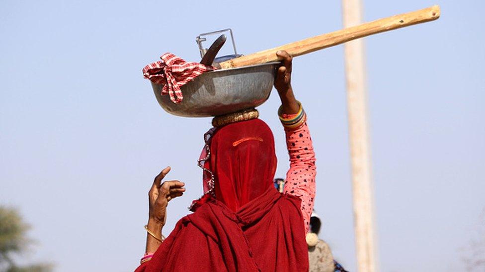 An Indian labourer going to work under the Mahatma Gandhi National Rural Employment Guarantee Scheme on the outskirts of Ajmer, Rajasthan, in May 2020