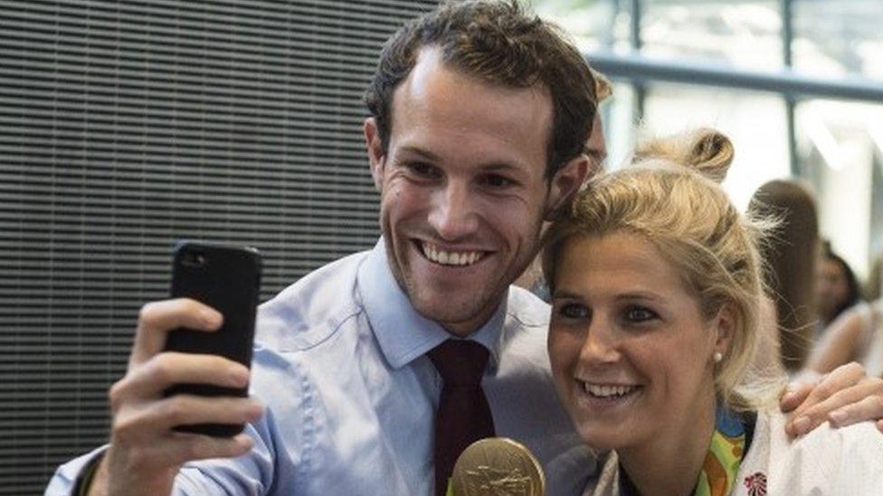 Olympic hockey player Georgie Twigg (right) of Team Great Britain (GB) is greeted as she arrives back in London