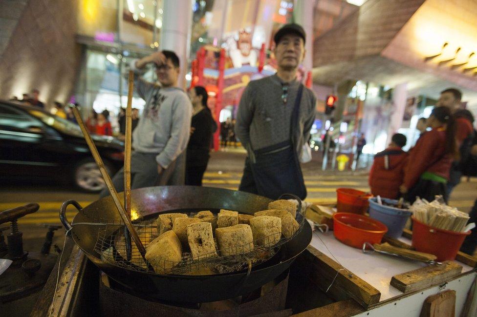 A street hawker sells "stinky tofu" in Portland Street, Mong Kok, Kowloon, Hong Kong, China, 9 February 2016