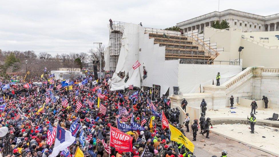 Protesters climbed the bleachers that were erected for Biden's inauguration