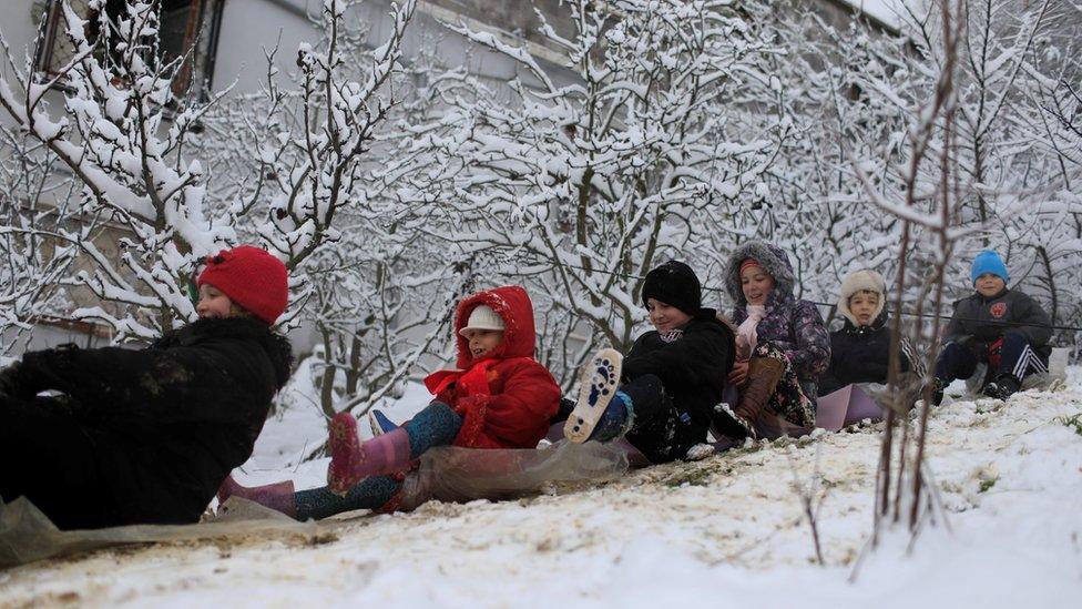 Children sliding down a snow-covered slop in Medea, Algeria - Wednesday 18 January 2017