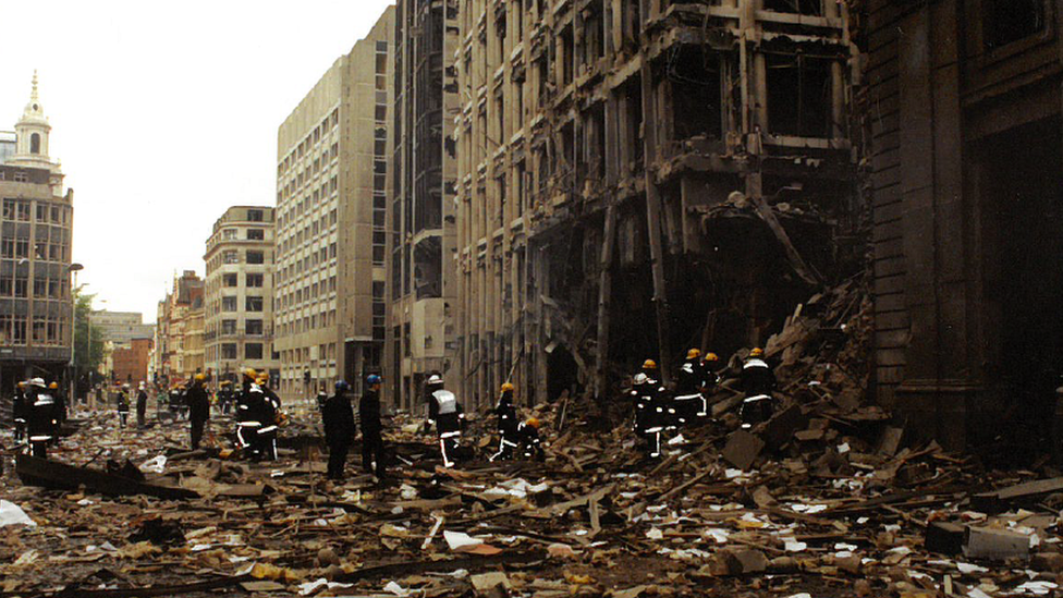 Fire crews clambering over rubble