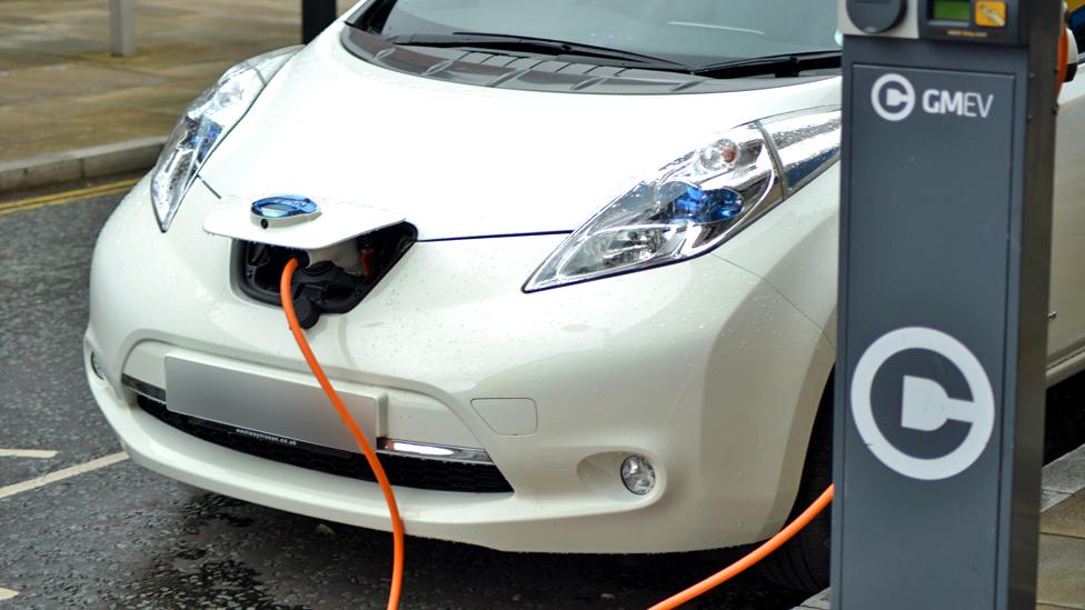 A Nissan Leaf car being charged at a public charge point