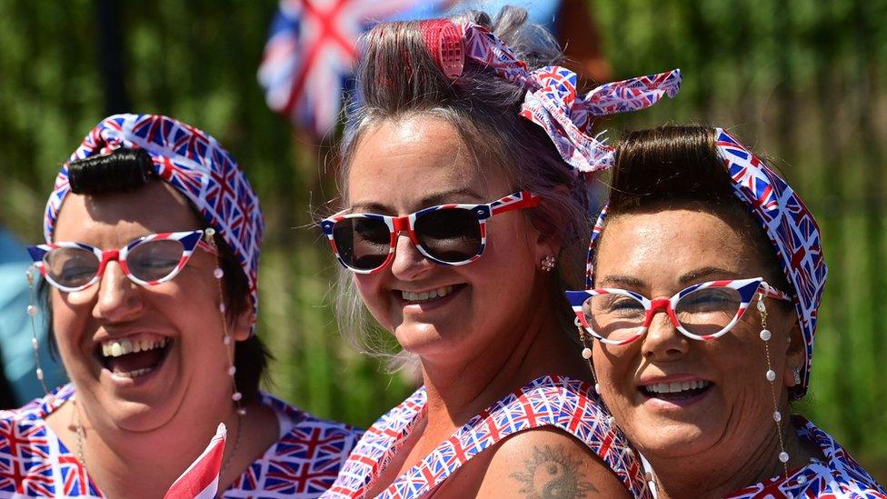 Three women wearing union jack outfits on Shankill Road