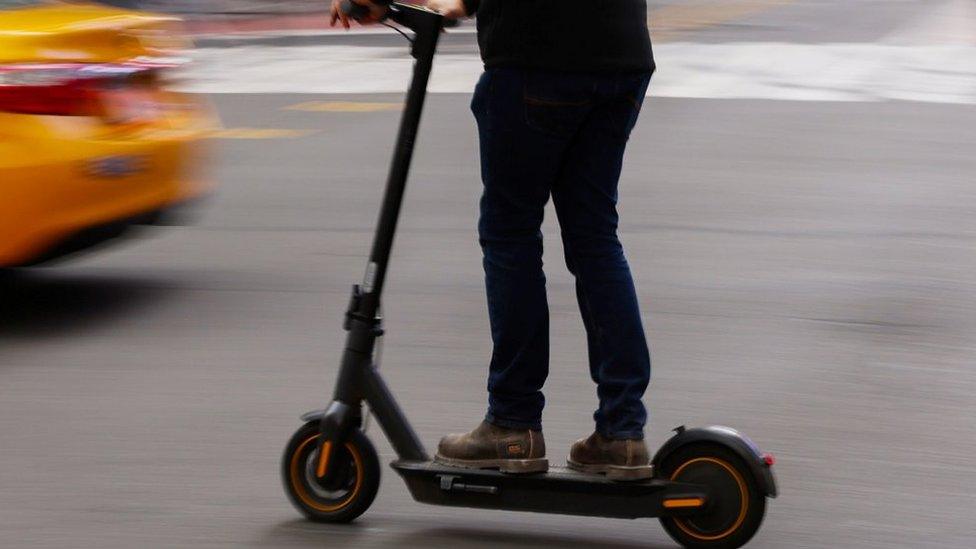 Close up of man on scooter