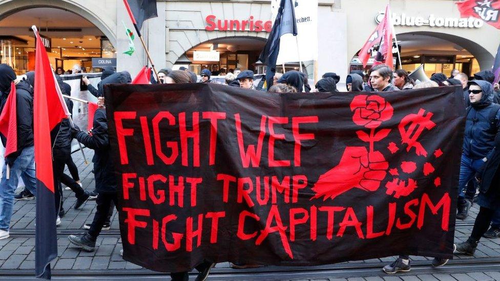 People take part in a protest against the planned visit of the US president to the World Economic Forum in Davos, in Bern on January 13, 2018