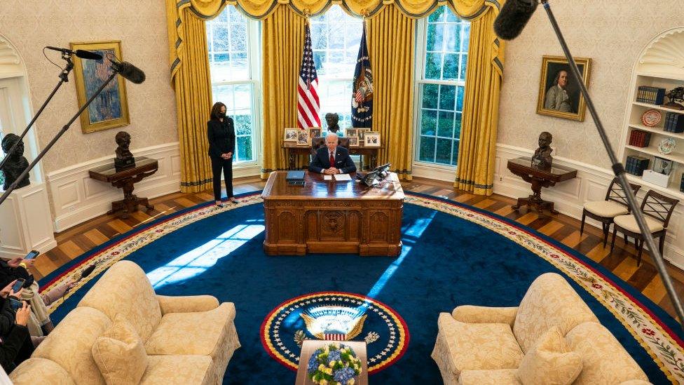 President Joe Biden speaks to reporters before signing executive actions in the Oval Office in January