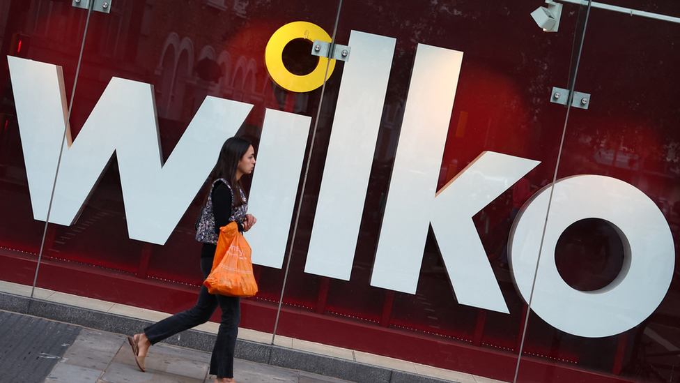 Woman walks past Wilko shop