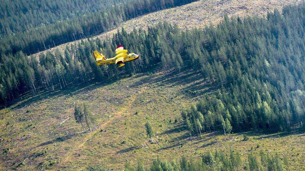 An Italian Bombardier CL-415 SuperScooper in action battling a large wildfire near Ljusdal, Sweden on 18 July 2018