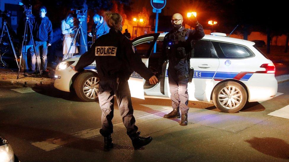 Police officers secure the area near the scene of a stabbing attack in the Paris suburb of Conflans-Sainte-Honorine, France. Photo: 16 October 2020.