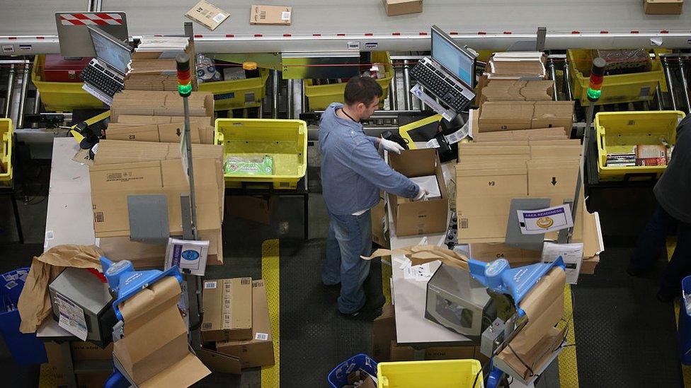 Amazon worker with cardboard boxes