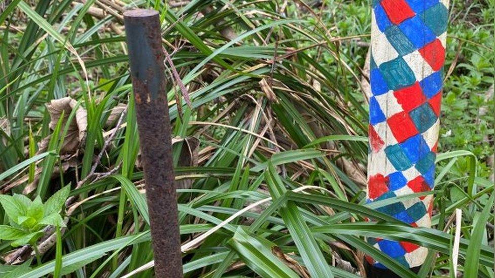 The base of one of the totem poles still left in the ground