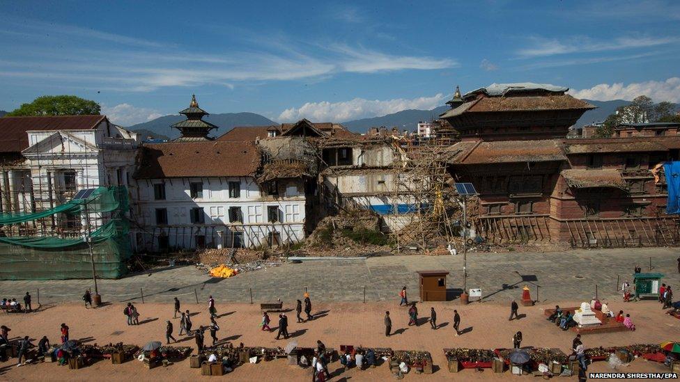 A line of tourist shops in front of a damaged part of Kathmandu's Durbar Square, a UNESCO world heritage site