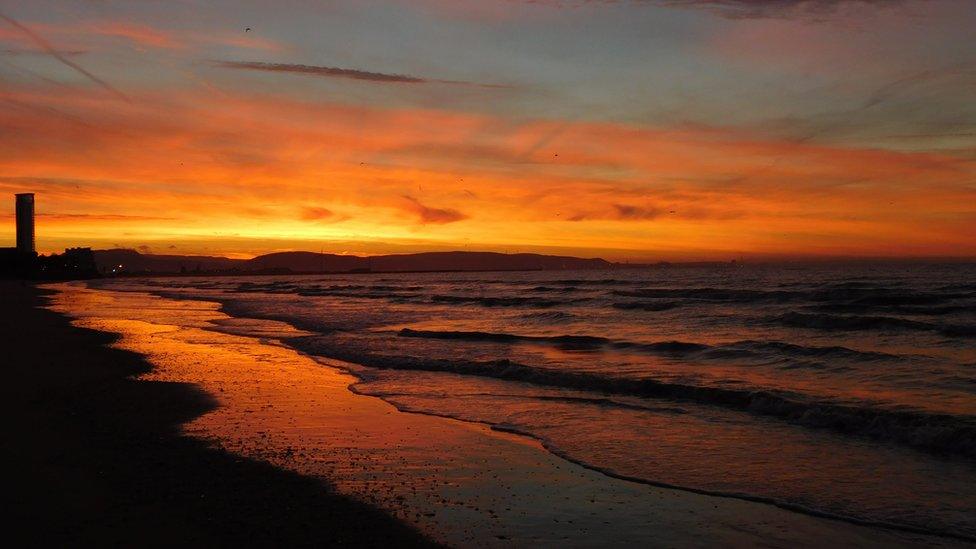 Red sky at sunset over Swansea beach