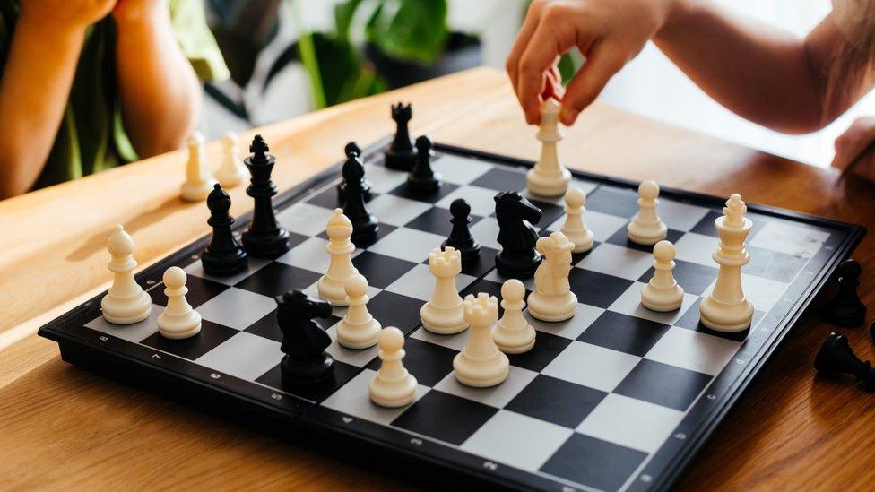 two people play a game of chess