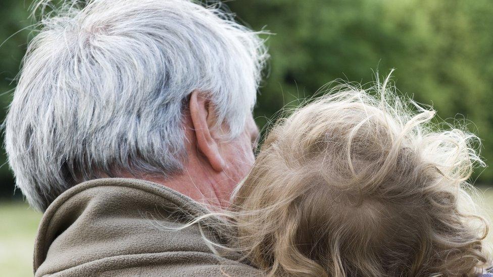 Grandparent holding child