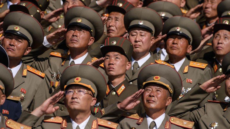 Korean People's Army (KPA) soldiers salute as they watch a mass rally on Kim Il Sung square in Pyongyang on 9 September, 2018.