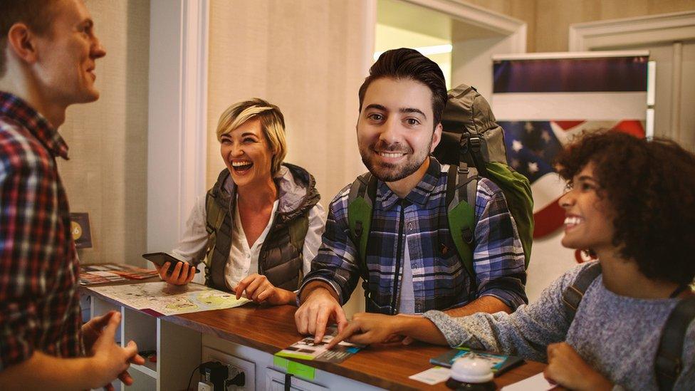 Ricky checking in to a hostel.