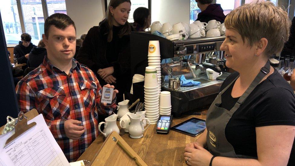 Conor using his JAM card in a cafe