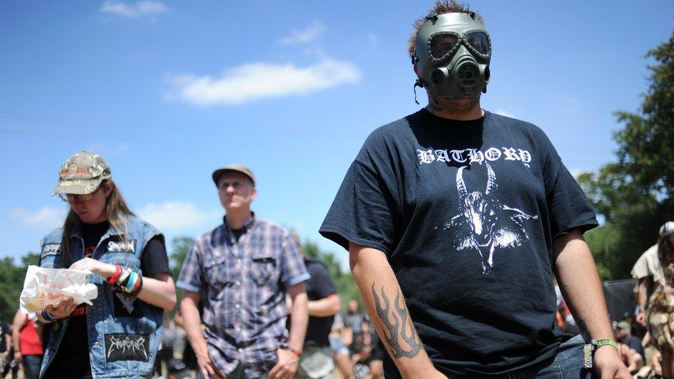 People wearing heavy metal t-shirts at a music festival