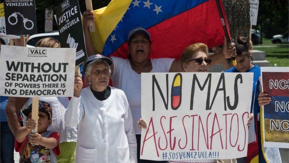 Supporters of the Venezuelan opposition demonstrate in front of the Organization of American States (OAS) headquarters in Washington, DC, on May 31, 2017 ahead of a meeting of Foreign Ministers of the OAS to discuss the situation in Venezuela.