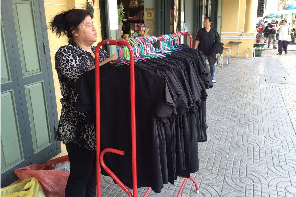 Street vendors are selling black T-shirts during the mourning period on 14 October 2016