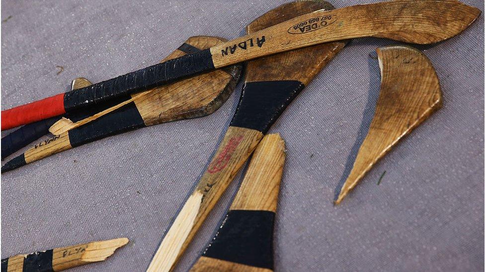 Broken hurleys sit near the Galway bench during the match against Dublin at the AIG Fenway Hurling Classic and Irish Festival at Fenway Park in 2017