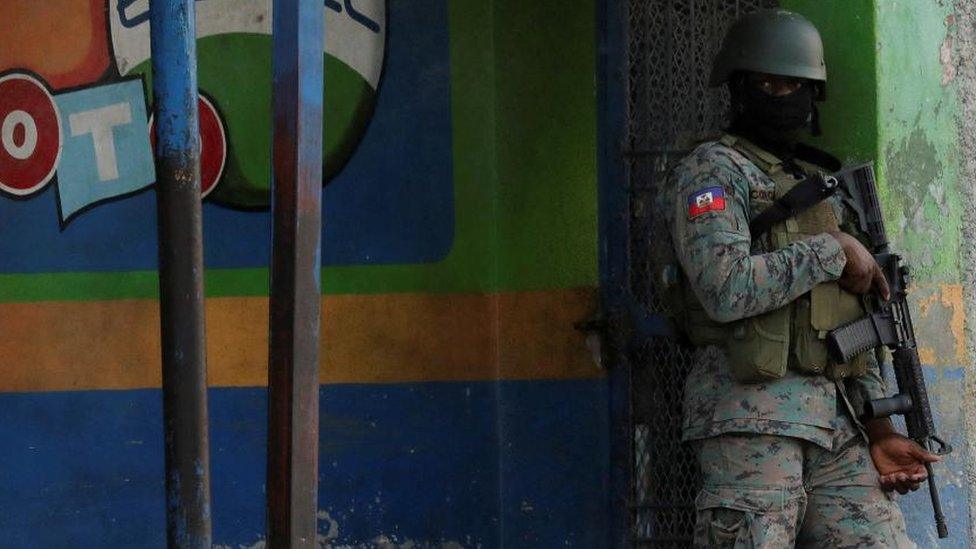 A Haitian soldier keeps watch near the Toussaint Louverture International Airport following a gunfight with armed gangs on the surroundings of the airport, as the government declared state of emergency amid violence, in Port-au-Prince, Haiti, March 4, 2024.