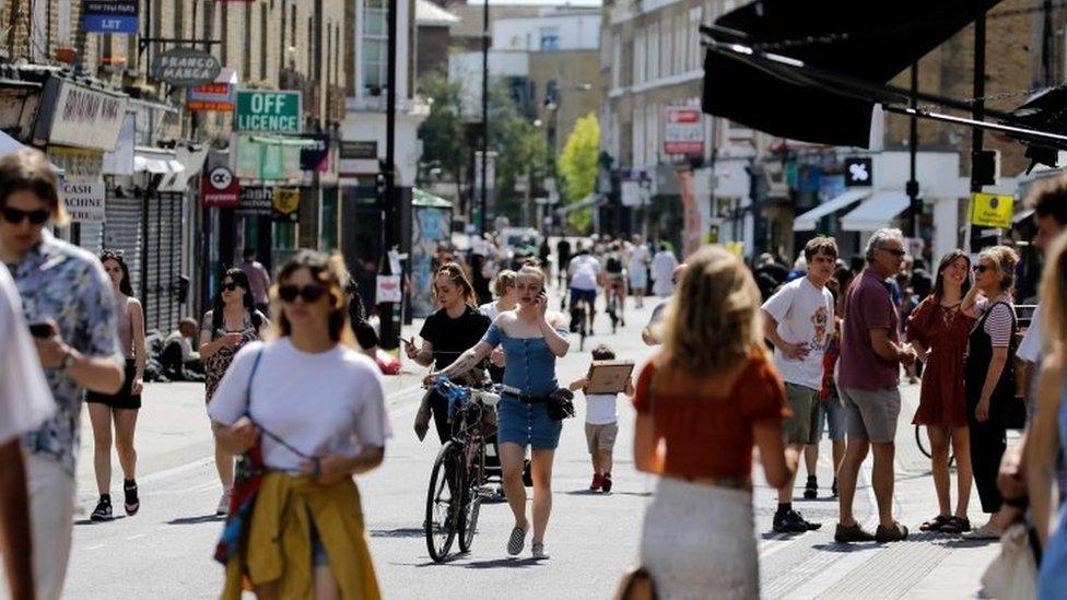 People get out in the sunshine in Broadway market, Hackney, north east London on 20 May