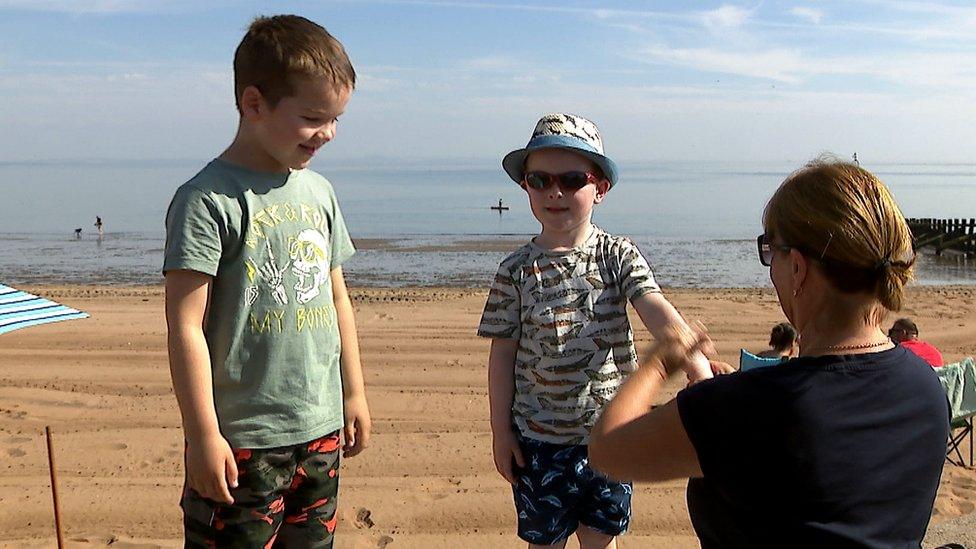 Family applies sunscreen on Portobello beach