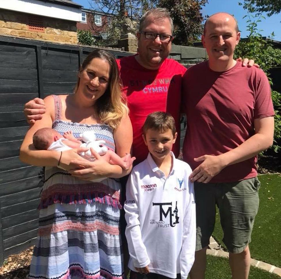 Robyn holding her son Teddy. She's standing next to her brother Gareth and his son, with her husband far right