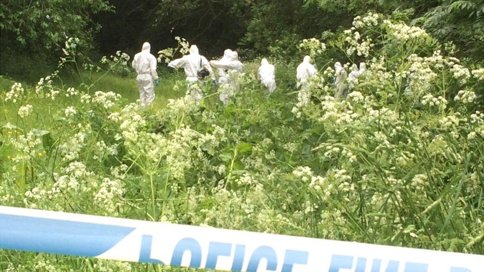 Forensic teams search nearby land
