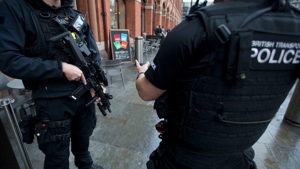 Armed British police officers maintain their usual patrol outside St Pancras international railway station in London, Monday, Dec. 7, 2015.