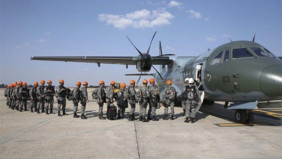 A handout photo made available by the "Agencia Brasil" shows National Forces members before boarding a plane to fight the fire at the Amazon forest in the state of Rondonia, Brazil, 25 August 2019.