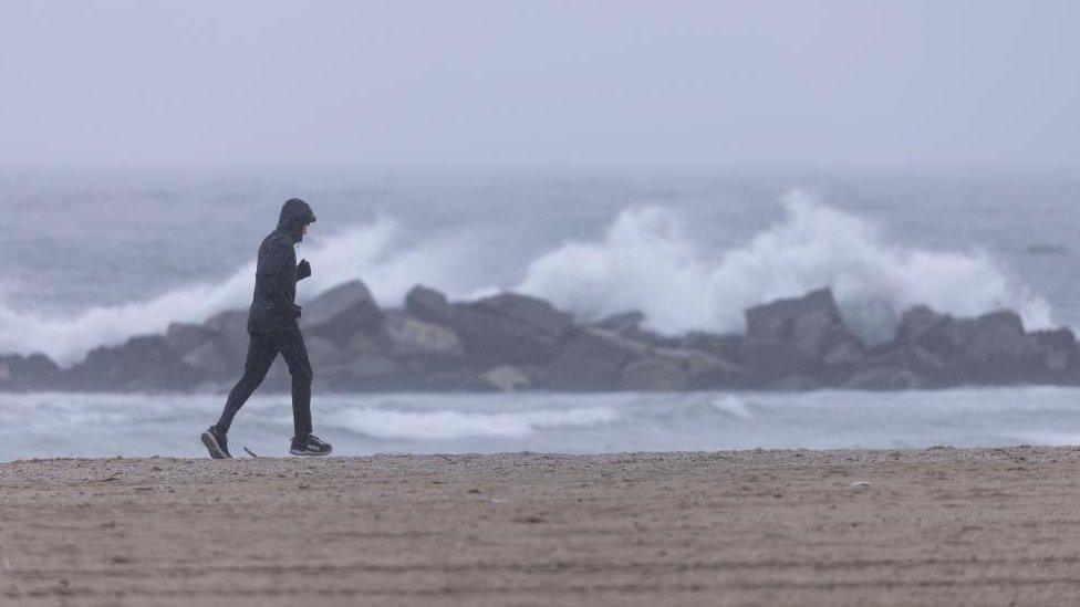 man jogging on beach