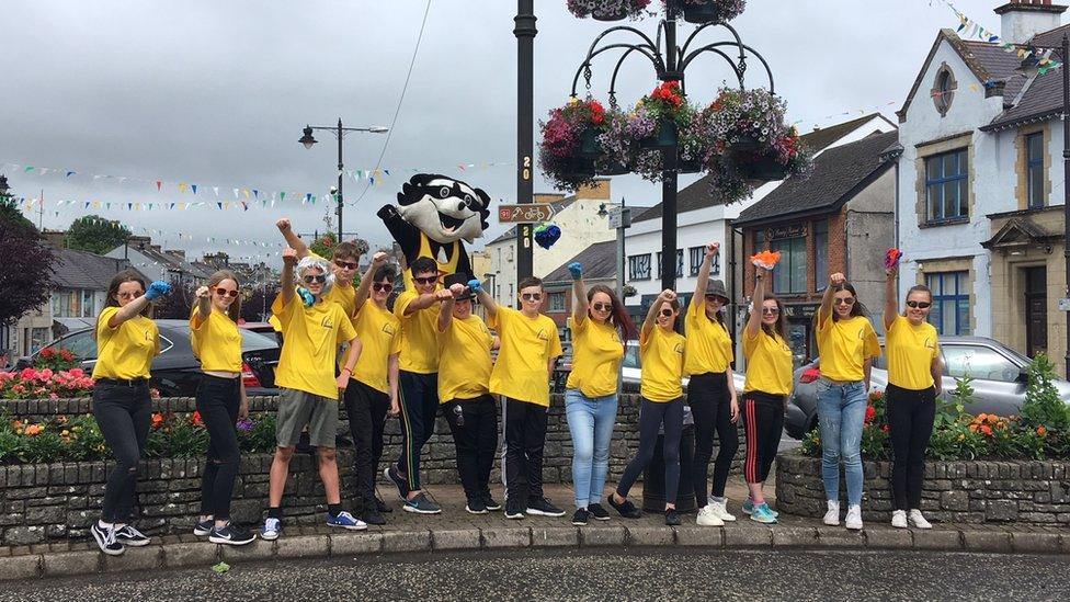 The children standing in the town centre just as they started displaying their flowers