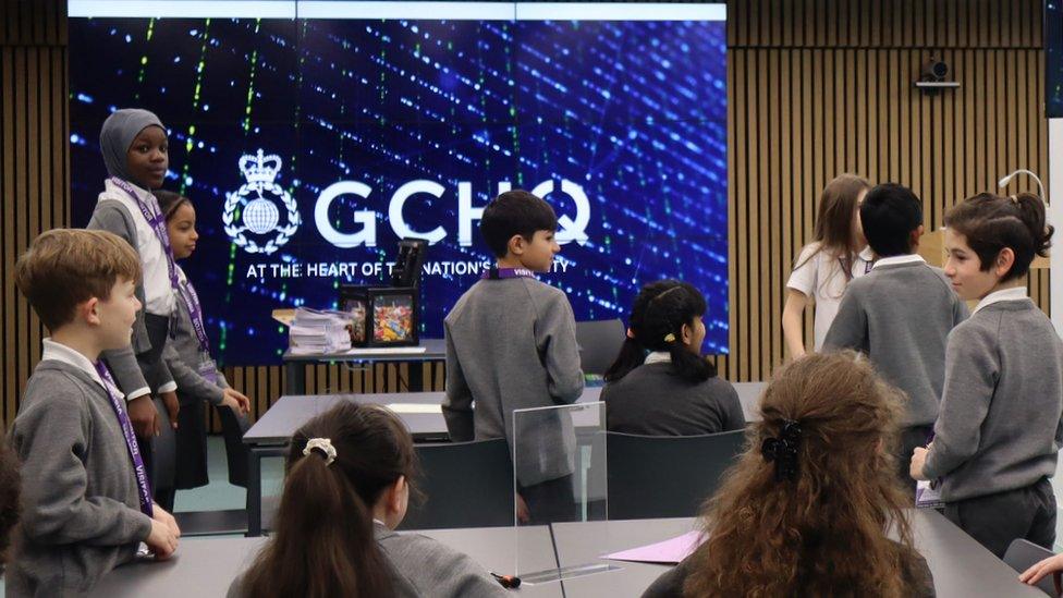 Handout photo issued by GCHQ of a local primary school class waiting the arrival of King Charles III during his visit to GCHQ's North West base in Manchester